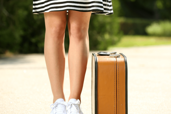 woman with suitcase preparing for her varicose vein treatment near me